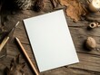 © Aliaksandr Siamko - A white piece of paper sits on a wooden table with a pencil and a candle