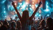 © Alpa - Woman standing in a crowd of people raising her hands up at a concert or festival. Concept of joy and celebration