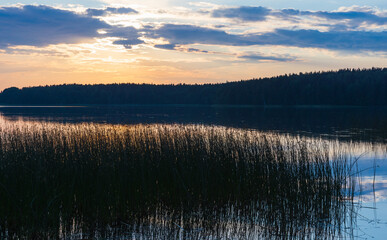 Wall Mural - coastal landscape with colorful sunset sky over calm still lake