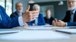 © TH_Stock - Close-up of a businessman's hand gesturing during a meeting, emphasizing communication and decision-making. Blurred background shows colleagues, creating a focused and collaborative environment.