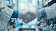 © Mehemmed - Science handshake and agreement in laboratory for success deal or gratitude Teamwork medical research and scientist shaking hands in gloves for partnership collaboration or welcome for doctors