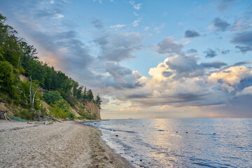 Wall Mural - Scenic landscape of forest-covered coast of Baltic sea. Sandy beach. Beautiful, blue, cloudy sky. 