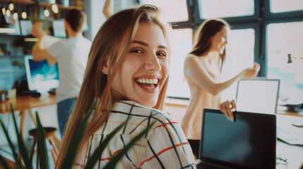 Sticker - A joyful office environment with a woman smiling brightly at the camera, and colleagues working in the background.