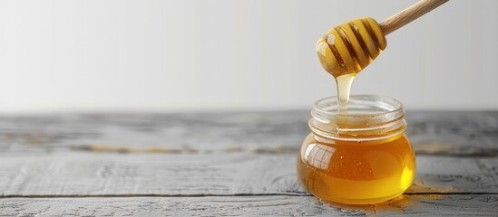 Wall Mural - Golden Honey Dripping into a Jar