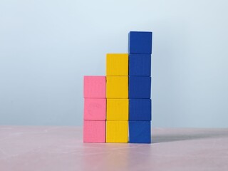 Wall Mural - Blank colorful cubes on light grey marble table