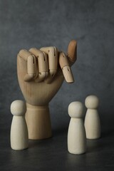 Poster - Wooden pieces and hand figure on grey table