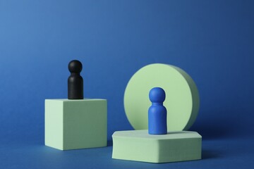 Wall Mural - Different figures on stands against blue background