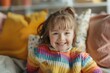 © Igor - Cute smiling little girl with Down Syndrome in bright clothes spending time at home