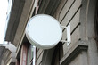 © SmartMockups - Rounded Street storefront shop, cafe, restaurant mounted signboard mock up design template. Blank white store sign design mockup.