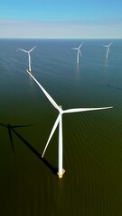 Wall Mural - A breathtaking aerial perspective showcases remarkable wind turbines situated on the water, highlighting the cuttingedge renewable energy technology being utilized in the Netherlands today