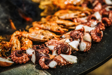 Sticker - Cooking shrimp, octopus and sausage on a large grill