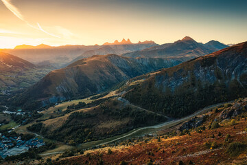 Wall Mural - Sunrise over Arves massif among French Alps with ski town in valley during autumn