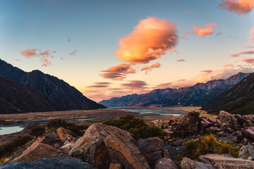 Wall Mural - Colorful sunrise over rocky mountain range on wilderness in autumn at New Zealand