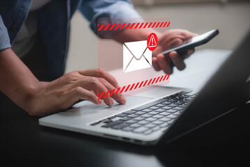 Fototapete - Person receiving spam email with warning alert on both laptop and smartphone. Cyber attack network, virus, spyware, cyber security and cybercrime.