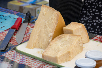 Traditional italian food, 36 months aged in caves Italian parmesan hard cheese from Parmigiano-Reggiano, Italy on farmers market