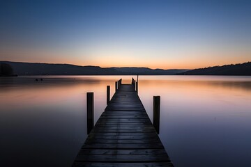 Wall Mural - Serene twilight over a tranquil lake pier at dusk.