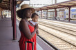 © Anna Berkut/Stocksy - woman with baby at railway station waiting for train