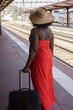 © Anna Berkut/Stocksy - summer holidays, woman travels with luggage, waiting for the train