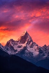 Poster - Silhouette of jagged mountain peaks with the sky painted in shades of orange, pink and purple colors,