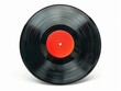 © vefimov - A black record with a red circle in the middle. The record is old and worn. The red circle is the center of attention and draws the eye. The record is a vintage item and has a nostalgic feel