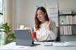 © PaeGAG - Young Professional Woman Having a Video Call While Working from Home Office with Tablet and Coffee