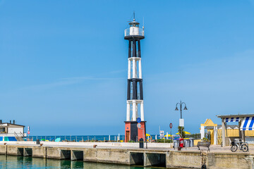 Wall Mural - A view towards the lighthouse in the harbour at Gabicce Mare, Italy in summertime