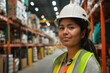 © Serhii - Immigrant Worker. Latina Warehouse Employee in Safety Gear Working in America