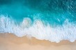 © JAYDESIGNZ - An aerial view captures the gentle embrace between the azure waves and the soft sandy beach, creating a tranquil and picturesque scene