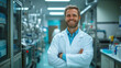 © Maksym - A technologist smiling in front of a high-tech production line for medical drugs