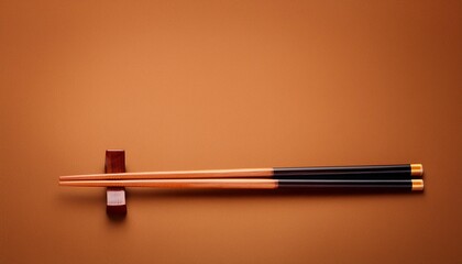 two chopsticks on a empty brown background