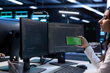 Poster - programmer in data center taking break from work, using isolated screen mobile phone to relax. worke