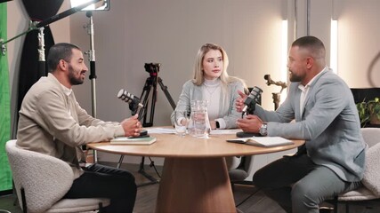 Fototapete - Podcast, people and meeting with mic in interview for live streaming, recording and guest on talk show. Discussion, info and host with celebrity in studio for news, broadcast and content creation
