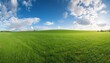 © Heaven - panoramic view of a beautiful green grass field with a blue sky and white clouds in the background