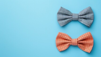 Wall Mural - Two bow ties, one blue and orange, on light background