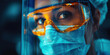 © khonkangrua - Close-up of a healthcare worker wearing a mask, protective goggles, and face shield, focused on her work.
