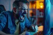 © Vorda Berge - Frustrated gamer screaming in anger yelling at computer screen after losing