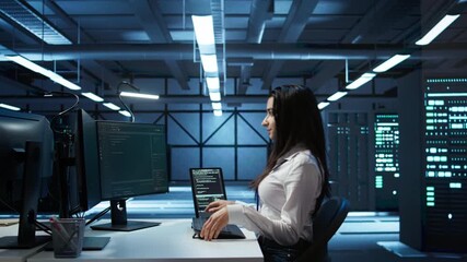 Poster - engineer in data center sitting down at desk, installing software on computer, troubleshooting issue