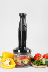 Poster - Hand blender kit, fresh vegetables and parsley on white background