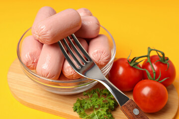 Wall Mural - Small sausages in a transparent bowl with fresh tomatoes