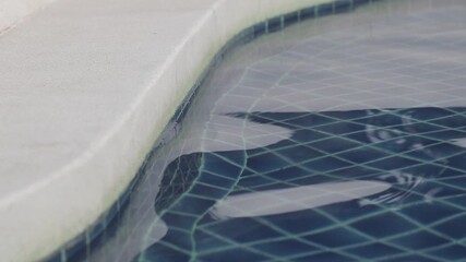 Wall Mural - water rippled pattern on blue water surface in swimming pool near pool edge.