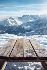 Wall Mural - A wooden table standing out on a snowy mountain peak background