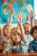 © pijav4uk - Group of children in classroom raising hands to answer educational questions