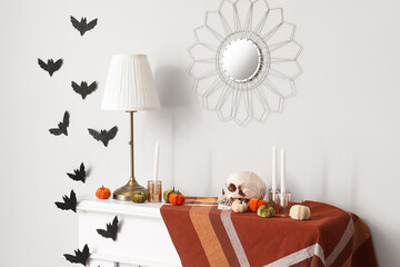 Wall Mural - Halloween pumpkins with skull, candles and lamp on fireplace in room