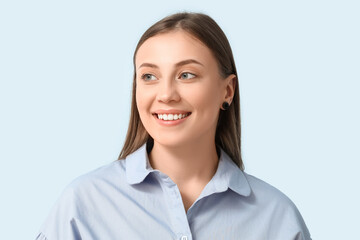 Poster - Beautiful woman smiling on blue background, closeup