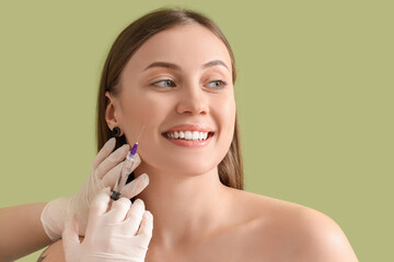 Poster - Beautiful woman receiving injection on green background, closeup