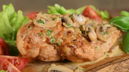 Wall Mural - Baked chicken drumsticks served with garlic-lemon-basil sauce, lettuce and vegetables. Circular movement from left to right.