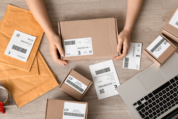 Sticker - Female postal worker with parcels on table, top view