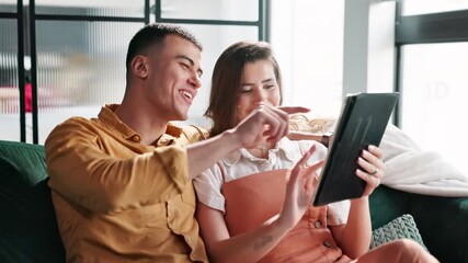 Poster - Couple, tablet and laugh on sofa in home networking on social media, mobile app or internet. Man, woman and browse with comic, funny joke or online meme with technology in living room at house