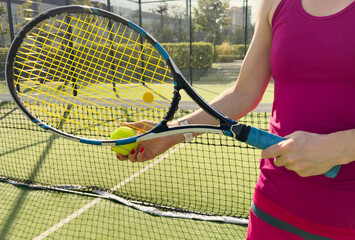 Woman with tennis racquet and ball