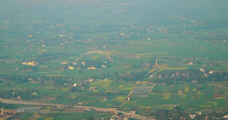 Poster - Varanasi, India. Aerial View From Airplane Window On View of the Benares villages. Houses are adjacent to green fields. Village Buildings against the backdrop of a green landscape. Travel And Tourism